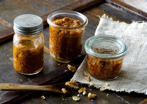 Eingemachte Walnusscreme in Weckgläsern auf einem Blech, von vorne fotografiert